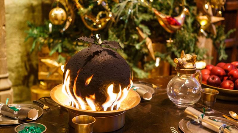 Christmas puddings adorn the tables in the Great Hall. Credit: Warner Bros. Studio Tour London – The Making of Harry Potter. Image courtesy of Warner Bros. Studio Tour London – The Making of Harry Potter. A flaming christmas pudding at the warner bros studio tour.