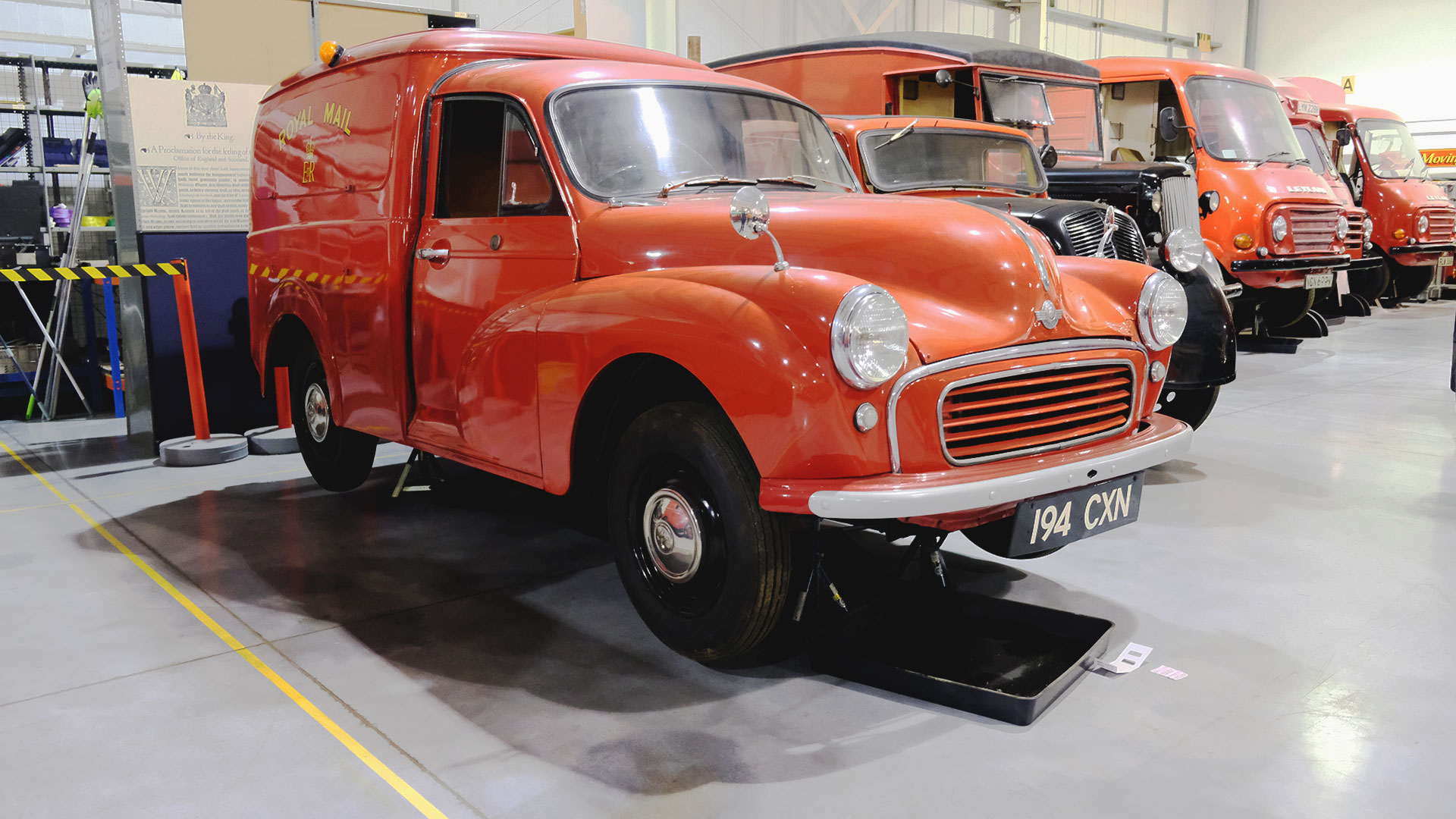 Explore some rare heritage vehicles, which are part of the Post Office's precious archive, and see them up close on a behind-the-scenes tour at the Postal Museum Store in Debden. Photo credit: Carole Rocton Post Office vehicles are lined up, with a red van at the front. This is part of the archive of exhibited vehicles at the Postal Museum Store in London.