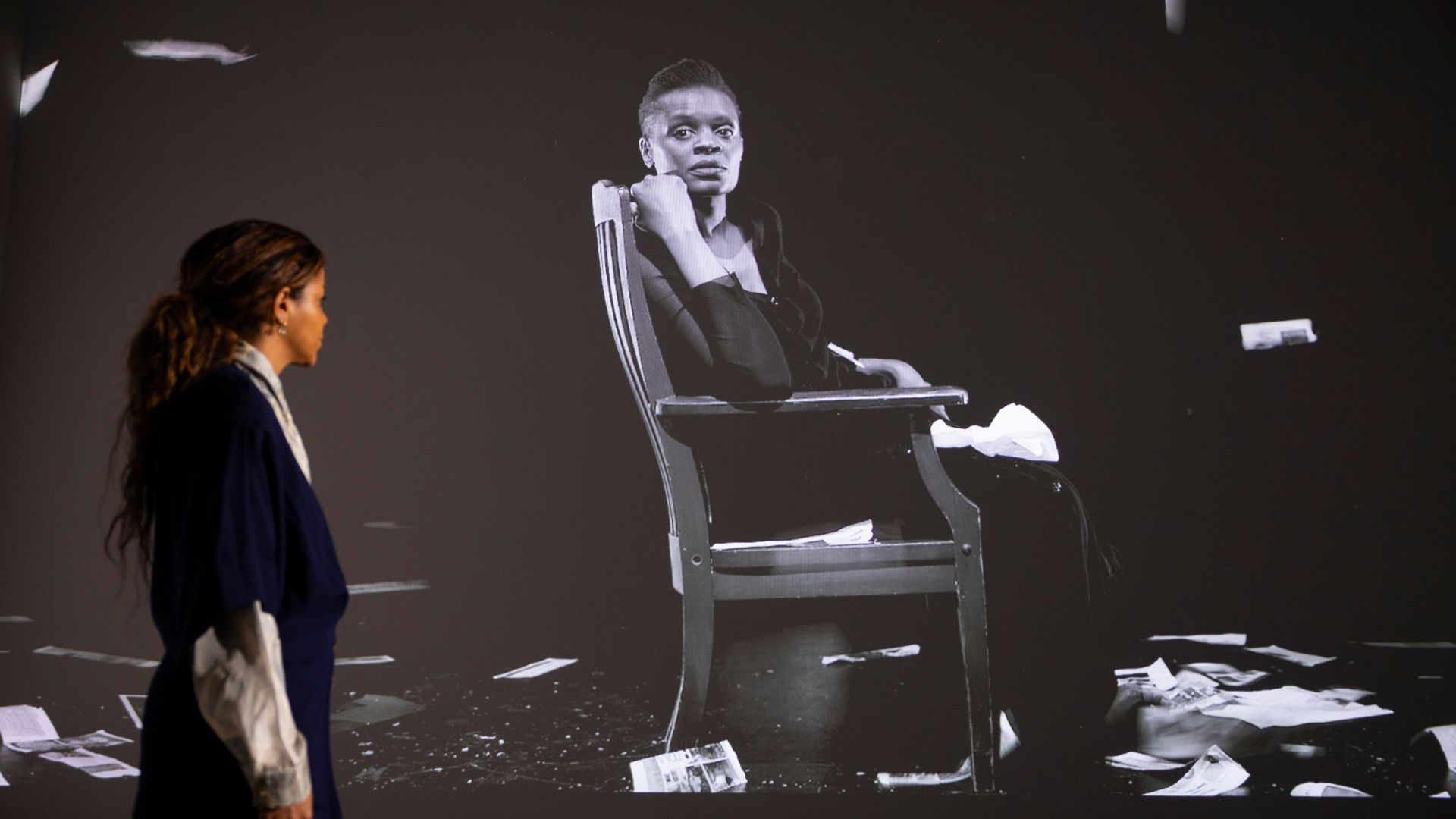 Uncover the theme Making East London in Carrie Mae Weems's film The Long Goodbye © David Parry for the V&A. Image courtesy of V&A East. Carrie Mae Weems's film The Long Goodbye in the background with person looking back at it.