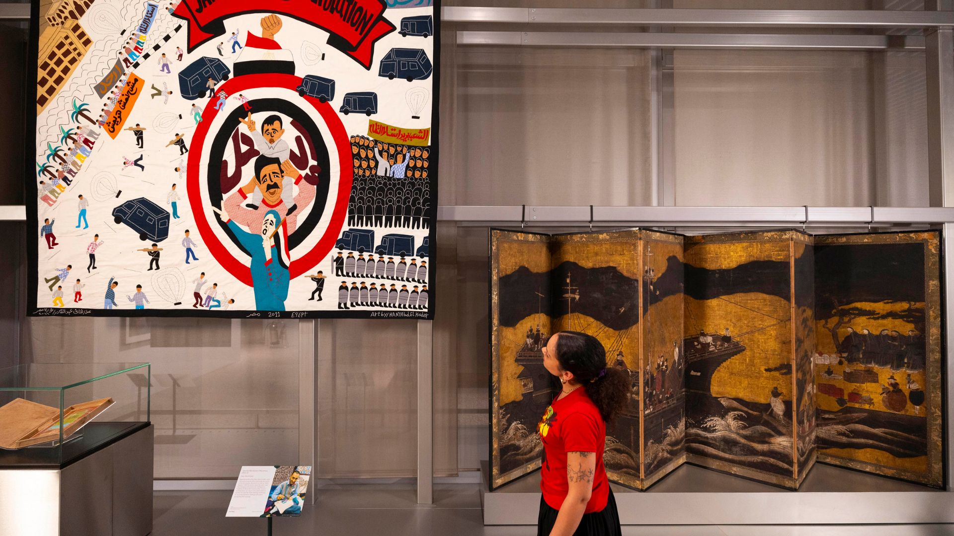 Experience global storytelling at V&A East Museum’s Why We Make galleries © David Parry for the V&A. Image courtesy of V&A East. Person looking up at tapestry on wall at V&A East Museum.