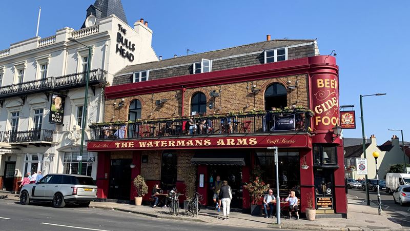 Flick through a menu of mouthwatering small plates at The Waterman's Arms, just a short stroll from the Thames. Credit: Shutterstock. Image courtesy of Shutterstock. A photo of the Waterman's Arms pubs from the front on a bright sunny day with people stood and sat on benches outside