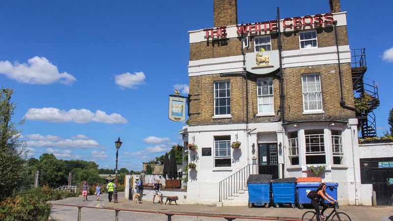Join the crowds that flock to The White Cross in Richmond for pints, sunshine and riverside views. Credit: Shutterstock. Image courtesy of Shutterstock. A photo of The White Cross pub in Richmond on a bright sunny day