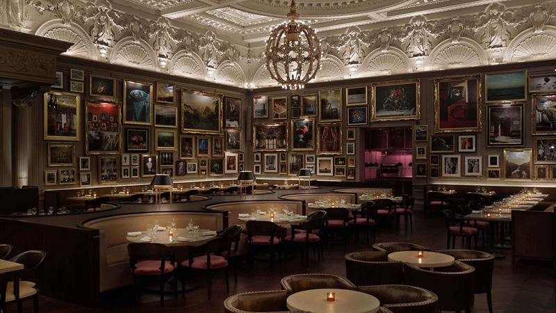Admire the luxurious surrounds inside Berners Tavern. Credit: Berners Tavern. Image courtesy of Berners Tavern at The London EDITION. Pictures hang on the wall inside of Berners Tavern restaurant in London.
