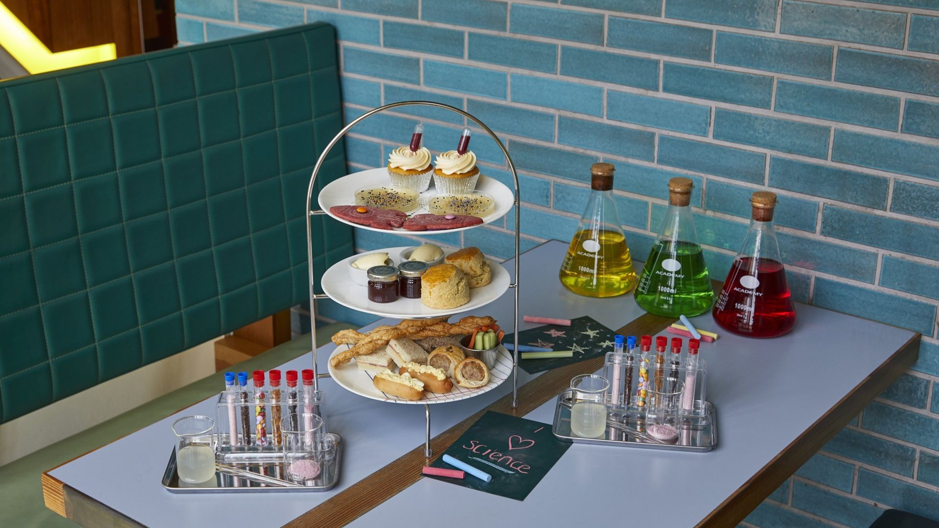 Spark curiosity with the playful Science Afternoon Tea at Science Museum, where budding scientists can tuck into themed treats inspired by experiments, discovery and the wonders of science. Image courtesy of Science Museum. A science-themed afternoon tea with cakes, sandwiches and colourful drinks presented alongside laboratory-style glassware and test tubes.