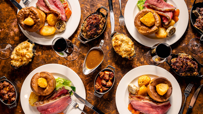 Share a delicious Hawksmoor Sunday roast with all the trimmings. Credit: Hawksmoor. Image courtesy of Hawksmoor. Four plates of Hawksmoor's Sunday roast with roast beef, vegetables, gravy and glasses of wine