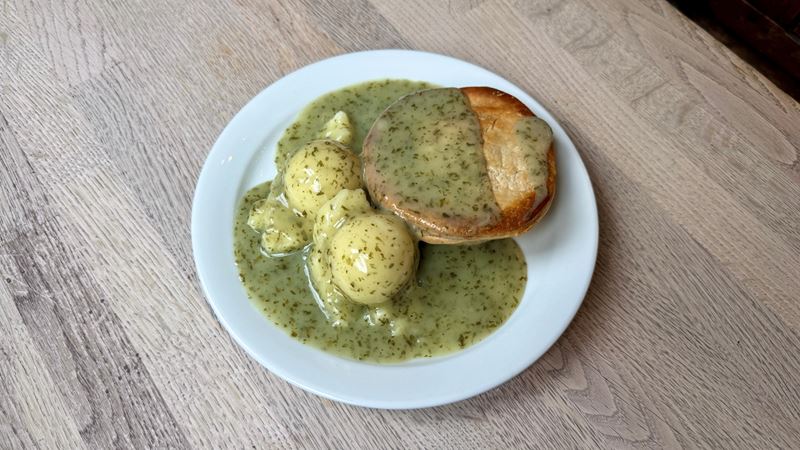 Warm up with a classic British pie and mash from family-owned Goddards at Greenwich. Credit: Lucie Fryer. Image courtesy of Lucie Fryer. A photo of a plate of food from Goddards at Greenwich with a pie, two scoops of pie and liquor sauce