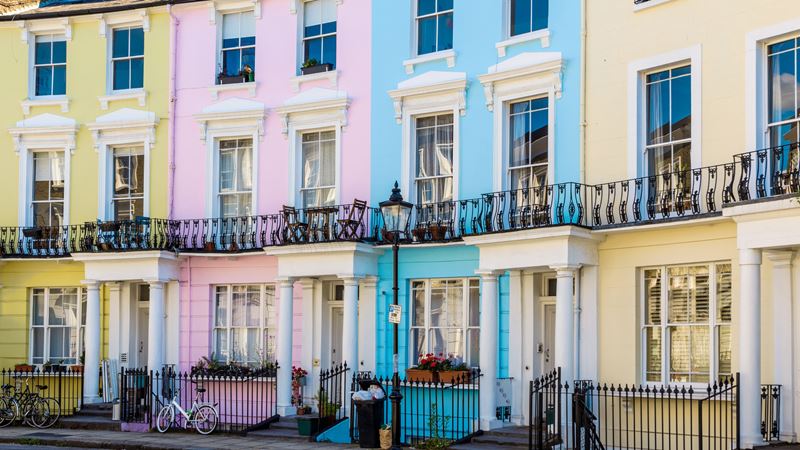Admire the colourful houses that line Primrose Hill and the surrounding area. Credit: Shutterstock. Image courtesy of Shutterstock. A photo of four colourful town houses on Chalcot Square in Camden, painted in a pale yellow, baby pink, bright blue and sherbert orange