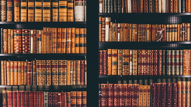 British Library in London, Photo by Andrea De Santis on Unsplash Collection of leather covered books at the British Library.