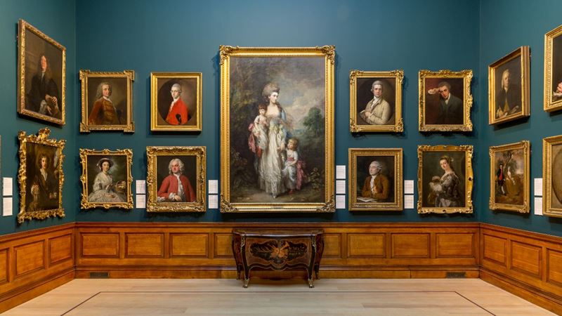 The Dulwich Picture Gallery houses more than 600 paintings. Credit: Dulwich Picture Gallery. Image courtesy of Dulwich Picture Gallery. Paintings hung on a dark green wall inside Dulwich Picture Gallery in Dulwich, London.