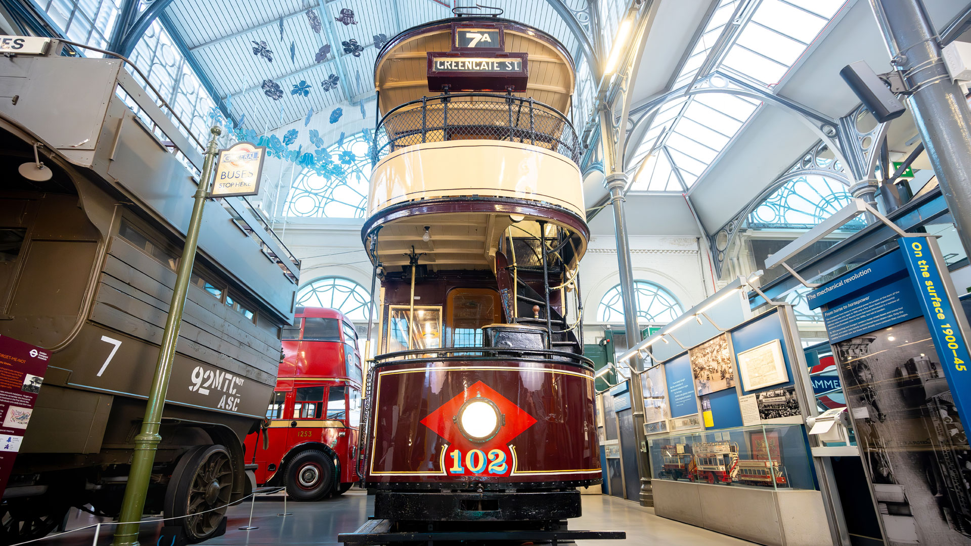 Discover London's transport history and enjoy interactive exhibits and collections at London Transport Museum. Image courtesy of London Transport Museum. low angle photo of an old London bus in the London Transport Museum, with old London transport vehicles in the background