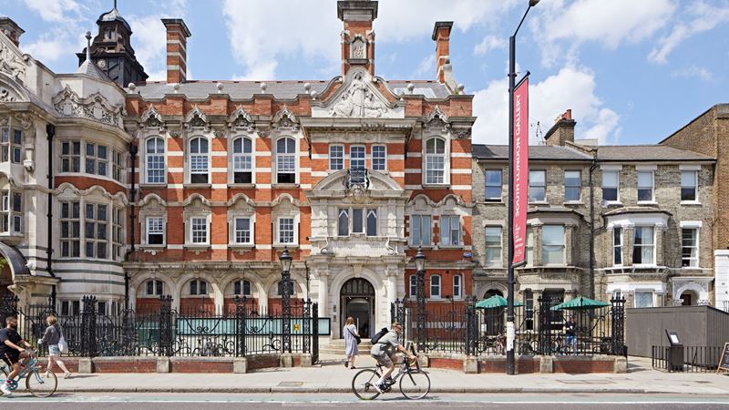 Explore South London Gallery. Image credit: Andy Stagg. Image courtesy of South London Gallery. Exterior of South London Gallery with person riding bike outside.