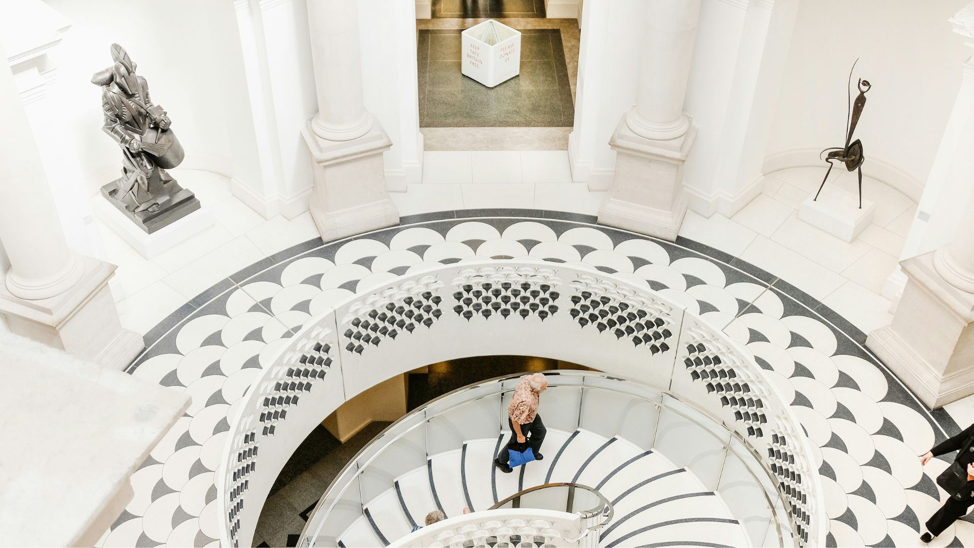 See the world’s largest collection of British art at Tate Britain. Image courtesy of Unsplash. Spiral staircase with person walking up it at Tate Britain.