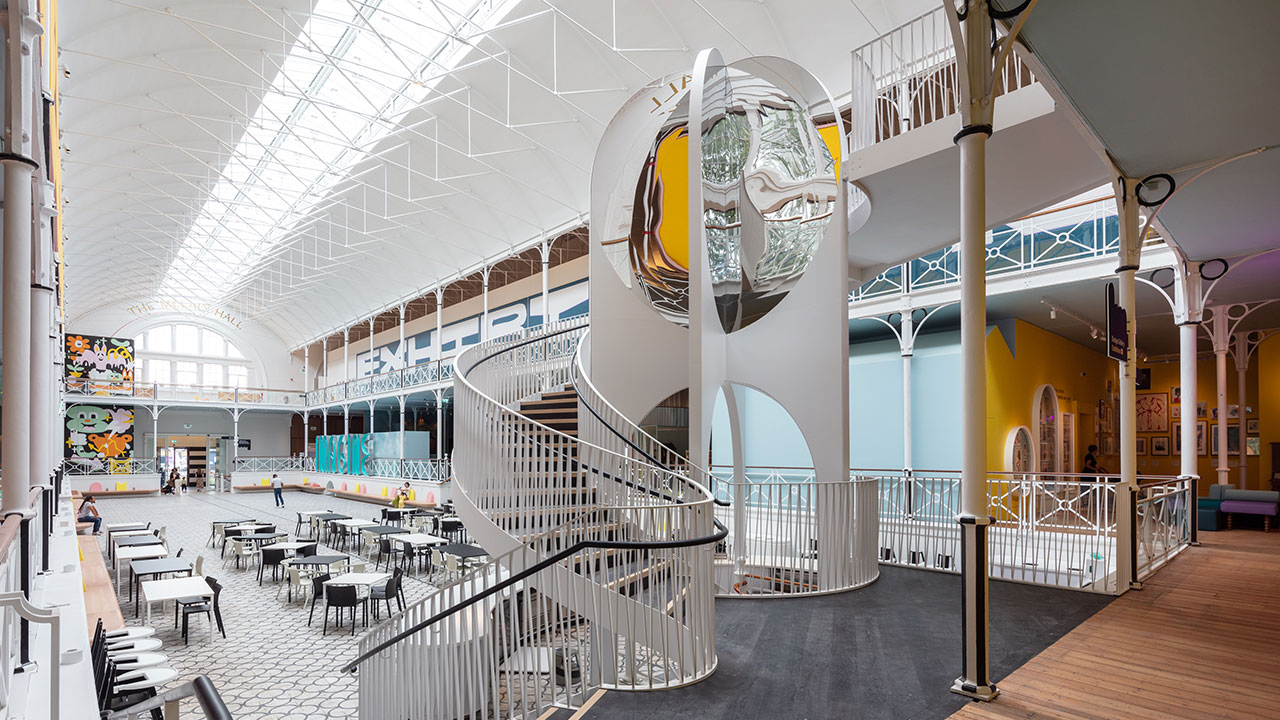Young V&A Feature Staircase. Image courtesy of Luke Hayes/Victoria and Albert Museum. A grey spiralling staircase in the Young V&A Museum