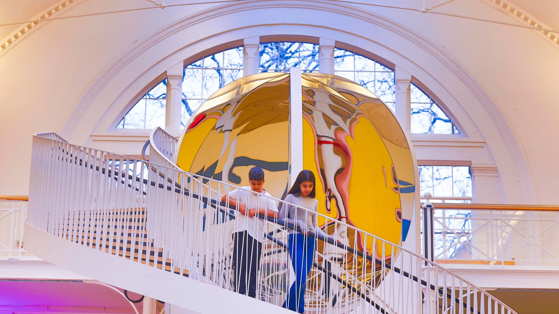 Children descend the spiral staircase beside a mirrored installation at Young V&A, London. © David Parry courtesy of Victoria and Albert Museum, London. Children walking down a spiral staircase beside a mirrored installation inside Young V&A, London.