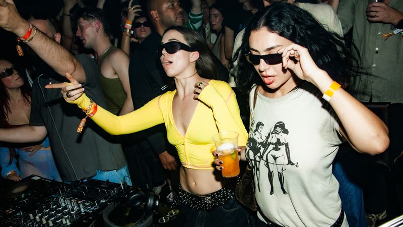 See unexpected names take to the main stage at Hackney Wick's beloved Colour Factory. Credit: Courteney Frisby. Image courtesy of Colour Factory. A photo of Charli XCX holding a beer while playing on decks among the crowd at Colour Factory