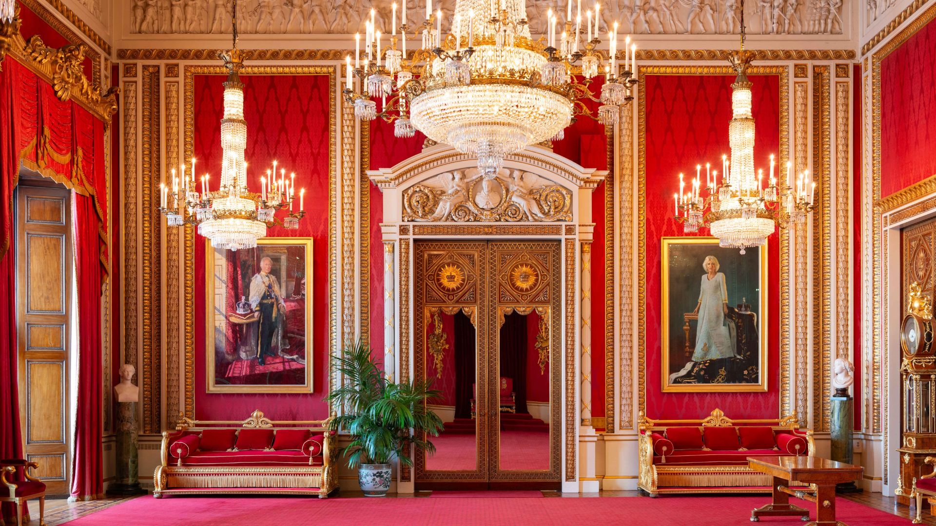 Be captivated by the grand interiors and get up close with royal portraits in the Throne Room at Buckingham Palace. © Royal Collection Trust. An opulent rec throne room with chandeliers and portraits at buckingham palace.