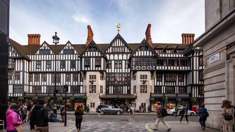 Liberty is a must-visit shopping spot on any London itinerary. Image courtesy of Shutterstock. The outside and main entrance to Liberty taken from across the road in Argyll Street with cars and people passing by.