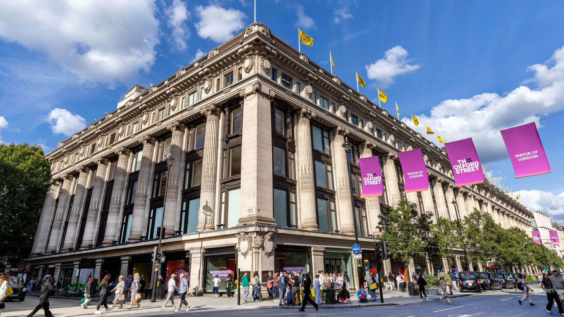 Discover six floors of clothing, shoes, accessories and more at Selfridges department store on London's Oxford Street. Credit: Peter Cohen. Image courtesy of London & Partners. A corner view of the outside of Selfridges department store on a sunny day.