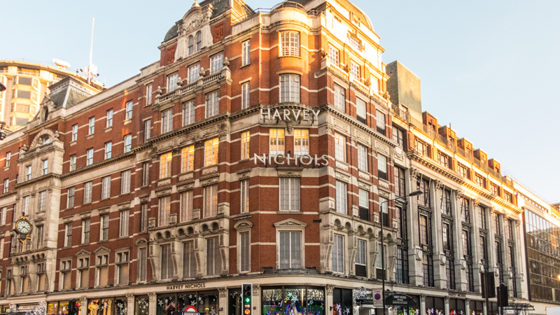 Head to Harvey Nichols to find clothes, bags, shoes and more from all the best luxury brands. Image courtesy of Shutterstock. A photo of the exterior of Harvey Nichols in Knightsbridge on a sunny afternoon with people walking outside on the streets