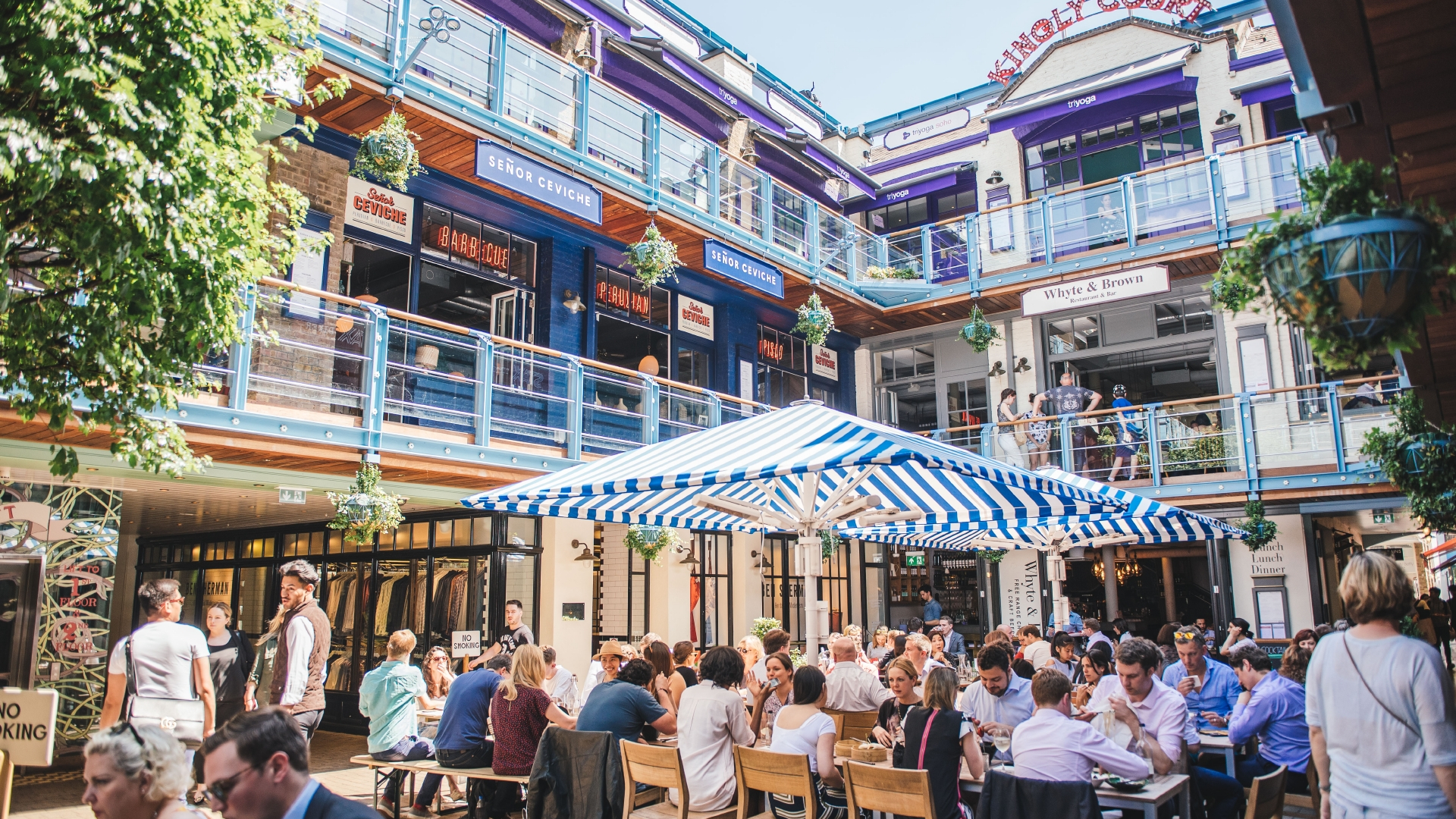 A unique urban retreat in London's West End, Carnaby offers a wide range of shops, restaurants and cafes. Image courtesy of Shaftesbury PLC. People eating out in London's Kingly Court in summer.
