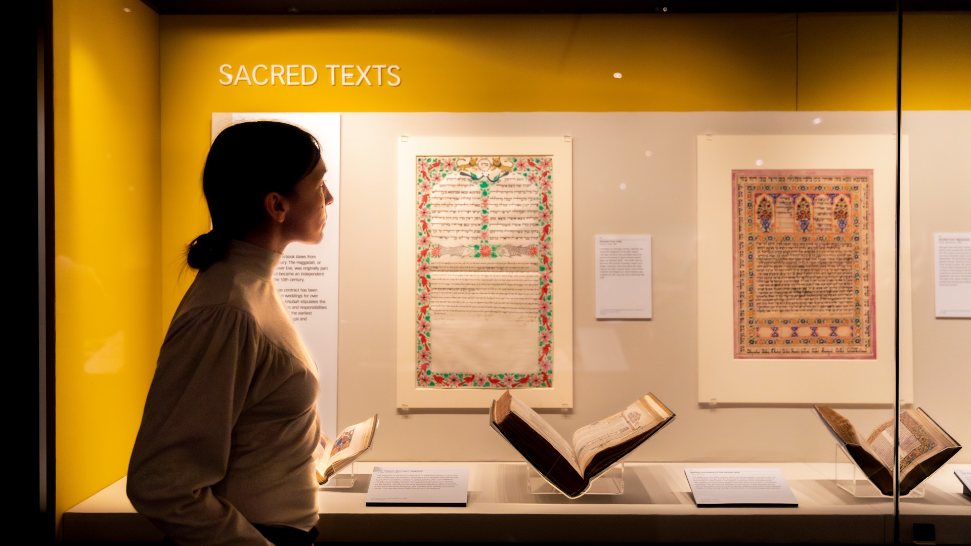 Explore the Treasures Gallery at the British Library featuring famous manuscripts, books and sacred texts © Sam Walton. Image courtesy of the British Library. A person looks at sacred texts, displayed in a glass cabinet, held within the Treasures Gallery at the British Library.