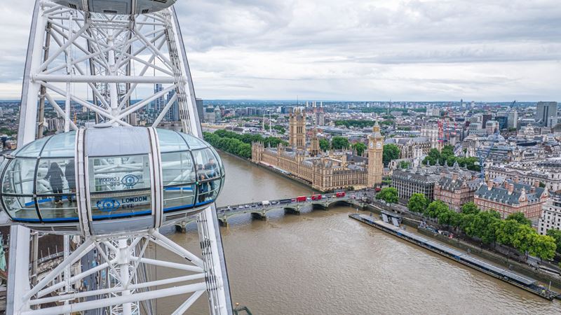 Enjoy 360-degree views of London's epic skyline from the London Eye. Credit: Jon Reid. Image courtesy of Visit London. View of London including the Thames and Big Ben from the London Eye with a capsule in the foreground.