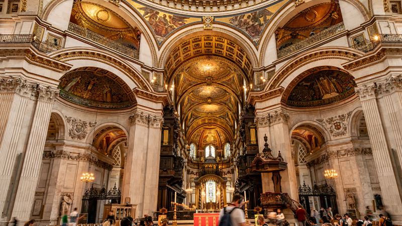 Visit St Paul's Cathedral and marvel at the architecture and memorials of great leaders who have walked within its walls. Image courtesy of London & Partners/Michael Barrow.. Visitors roam the walls of St Paul Cathedrals admiring its high ceilings.