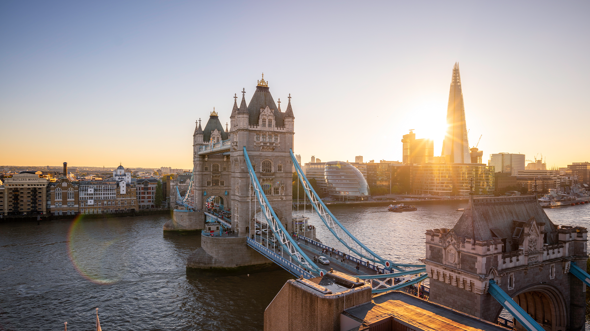 Sunrise at Tower Bridge. Image courtesy of London & Partners/Antoine Buchet. The sun rising behind The Shard and Tower Bridge