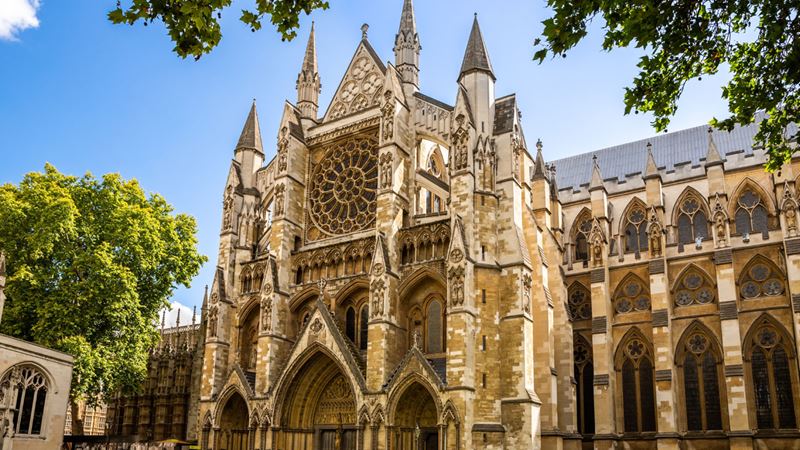 Visit Westminster Abbey, a London historic landmark and site of many royal events. Image courtesy of Shutterstock View on the front entrance of Westminster Abbey by a sunny day.