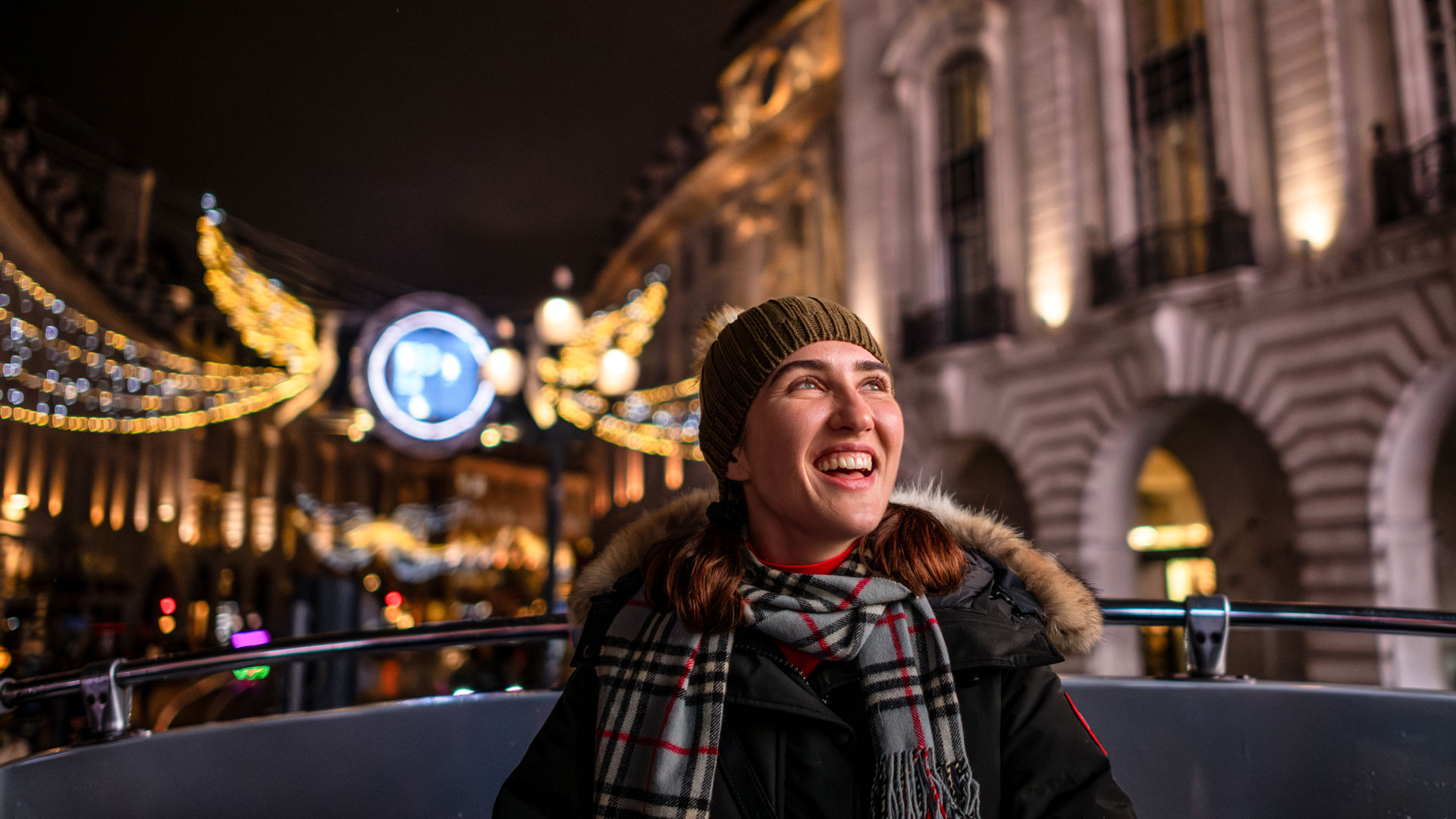 Take the Christmas lights bus tour to see London's top attractions. Image courtesy of London & Partners/Michael Barrow. A young woman sitting on the top deck of the Christmas Bus Light Tour seemed delighted by the spectacle.