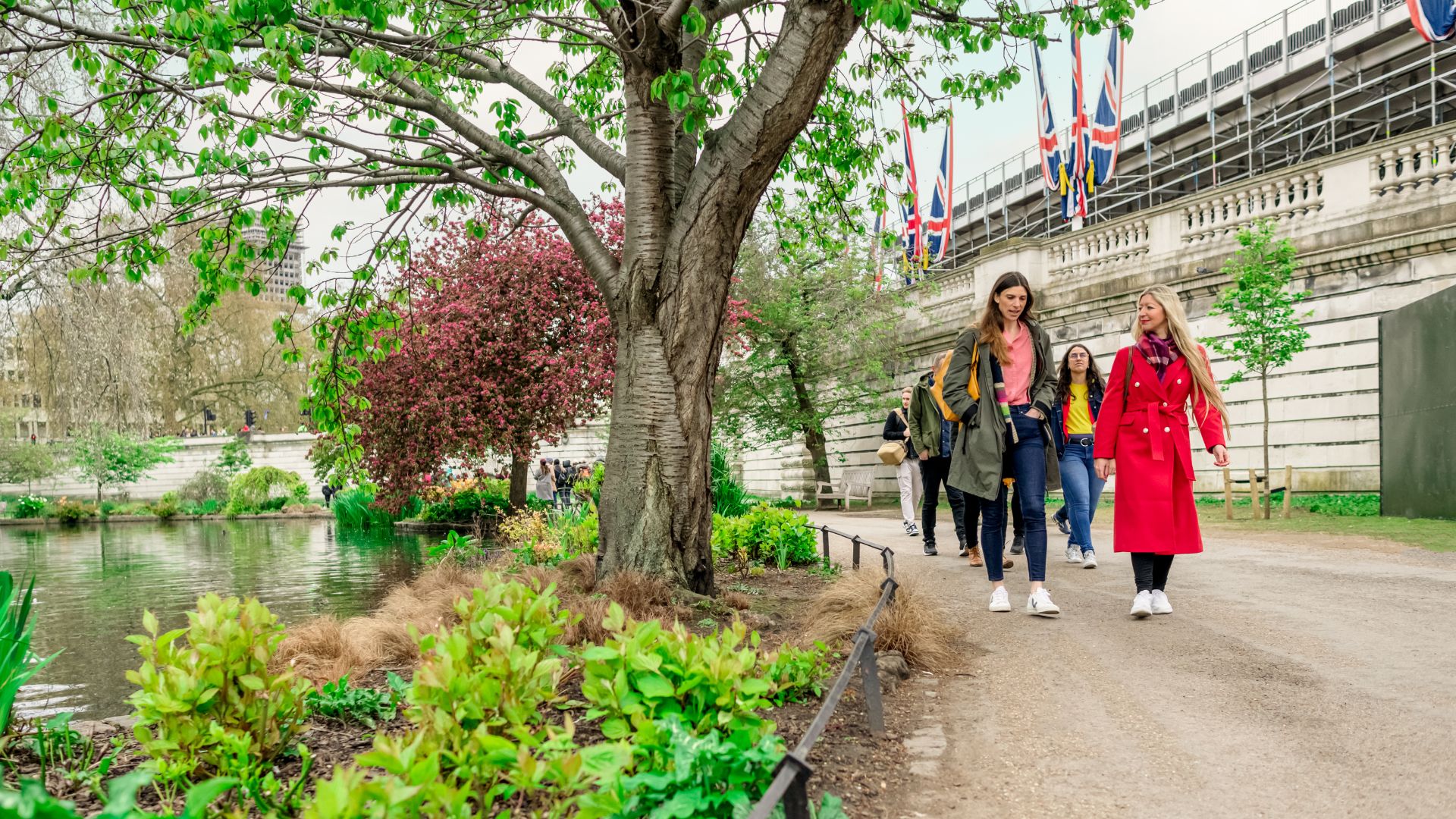 See the iconic Buckingham Palace from St James's Park, as you follow your guide on this royal London tour. © Visit London/Michael Barrow Two women following a path in St James's Park as part of the Royal Walking Tour in London.