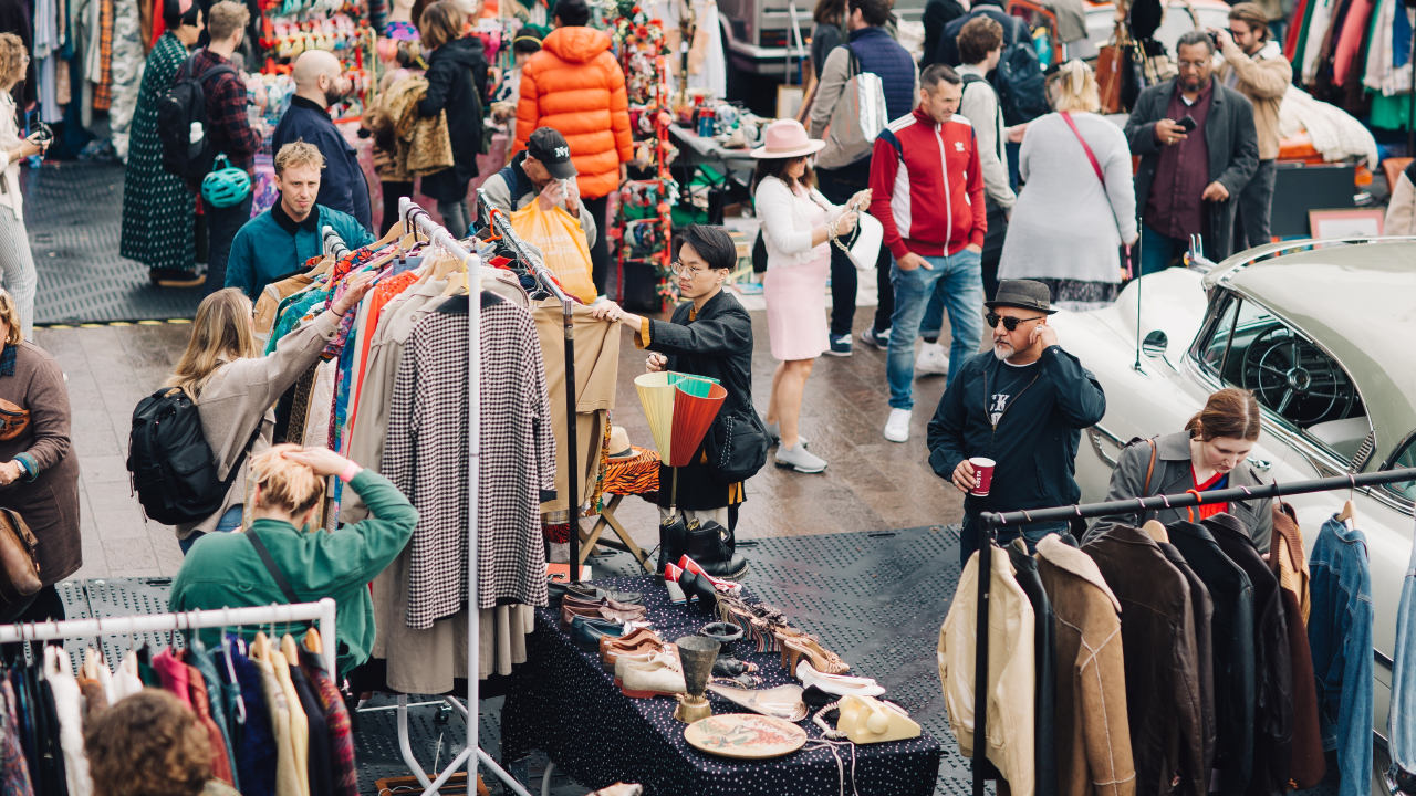 Browse for vintage and secondhand items at London's markets. Credit: Shutterstock. Image courtesy of Shutterstock. People browsing clothes and trinkets at a vintage market