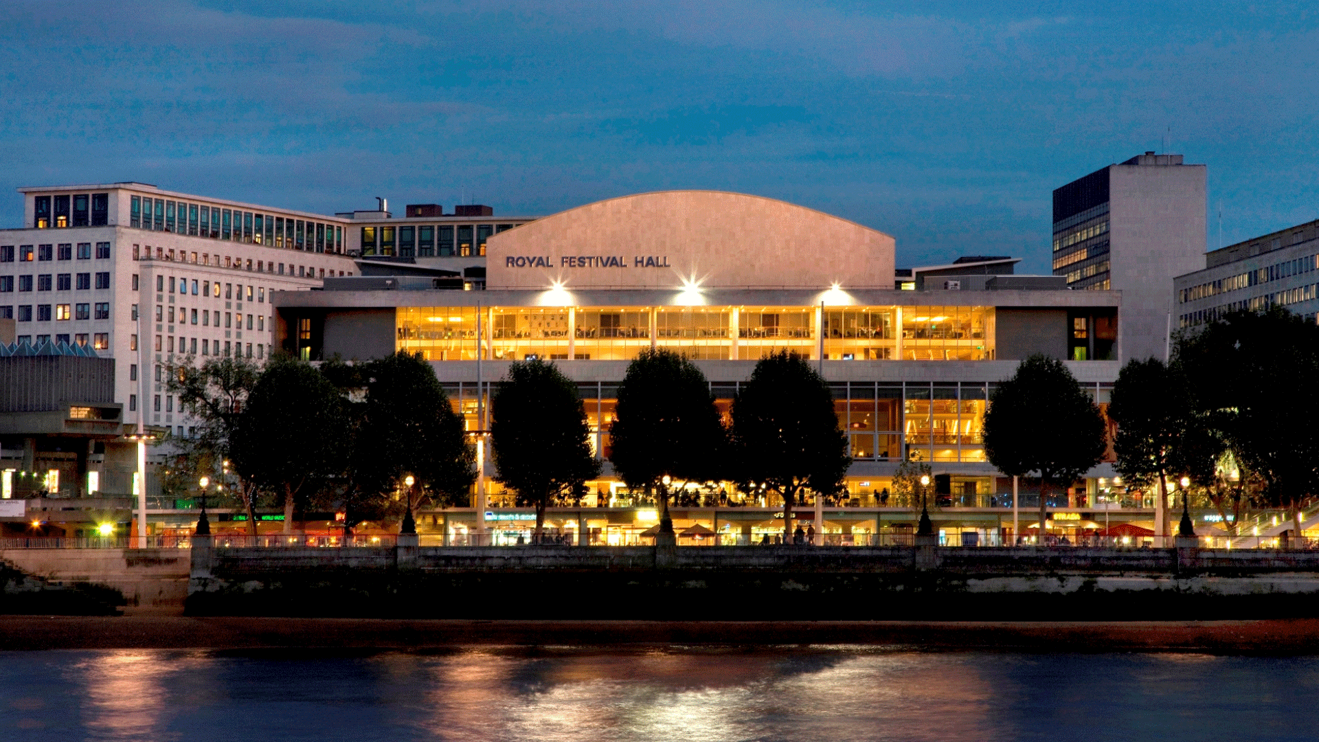 Royal Festival Hall at dusk. Image courtesy of Morley von Sternberg. A view of Royal Festival Hall on the south bank of the Thames from the other side of the river