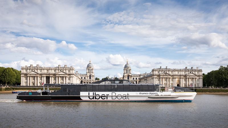 Float past iconic landmarks on your way to Greenwich. Credit: Uber Boat by Thames Clippers. Image courtesy of Uber Boat by Thames Clippers. The Uber Boat by Thames Clippers river bus floats along the river Thames past the Old Royal Naval College.