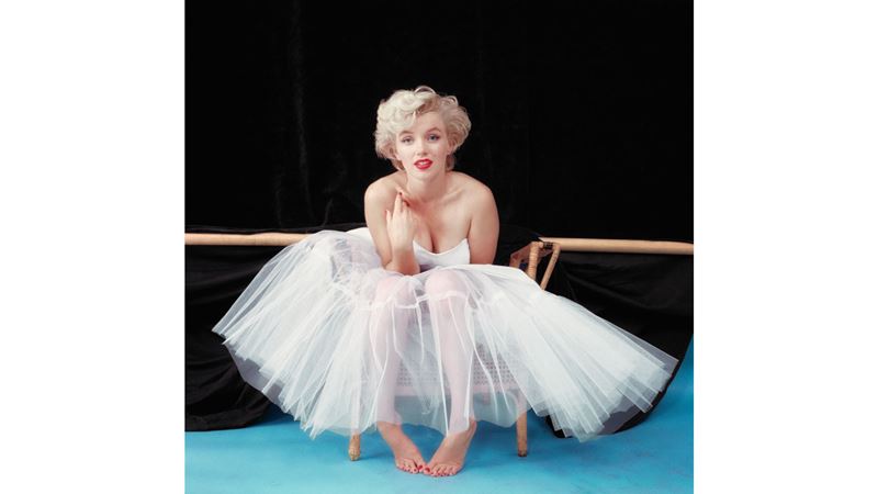 Marilyn Monroe, Ballerina Sitting, 1954, by Milton H Greene © MHG Collective, LLC. Image courtesy of National Portrait Gallery. Marilyn Monroe, sitting down, wearing in a ballerina's dress with bare feet.
