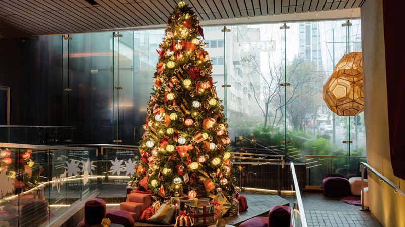 Colours of Arley designed this year's Christmas tree at Sea Containers. Credit: Alexander Baxter. Image courtesy of Sea Containers. A photo of the Christmas tree at Sea Containers covered in baubles and decorations made form textiles, stood in the hotel foyer