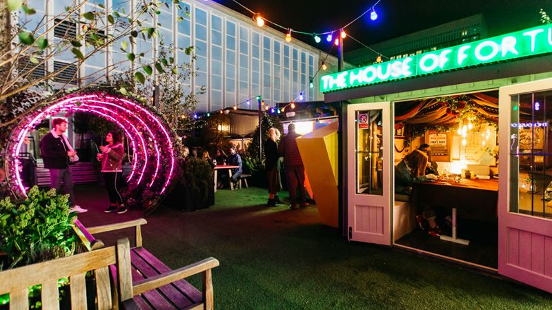 Discover the Winter Carnival at John Lewis Rooftop. Credit: John Lewis. Image courtesy of John Lewis. A photo of The Winter Carnival at John Lewis Rooftop, with some flashing banners and lights.