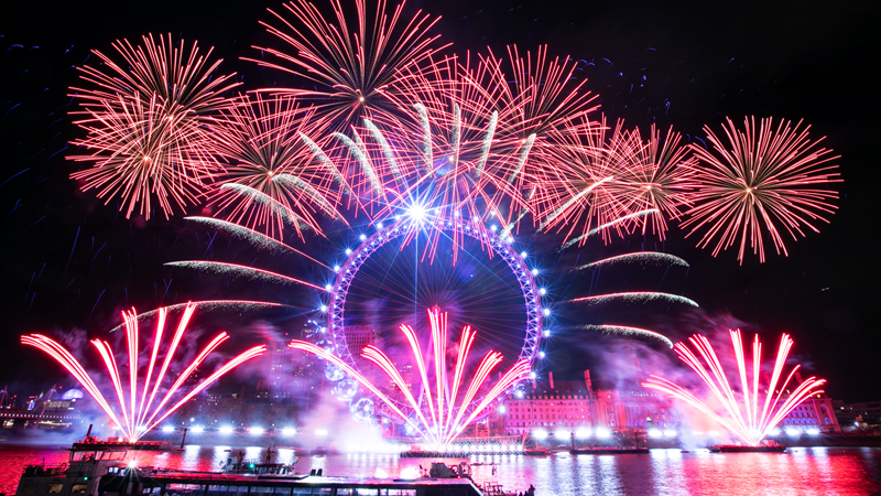 Say goodbye to the year with a brilliant firework display on New Year's Eve in London. Credit: Mayor of London. Image courtesy of Greater London Authority. A photo of the London Eye with pink and blue lights surrounded by the London New Year's Eve fireworks display with pink fireworks in the sky, around the London Eye and coming from the river Thames