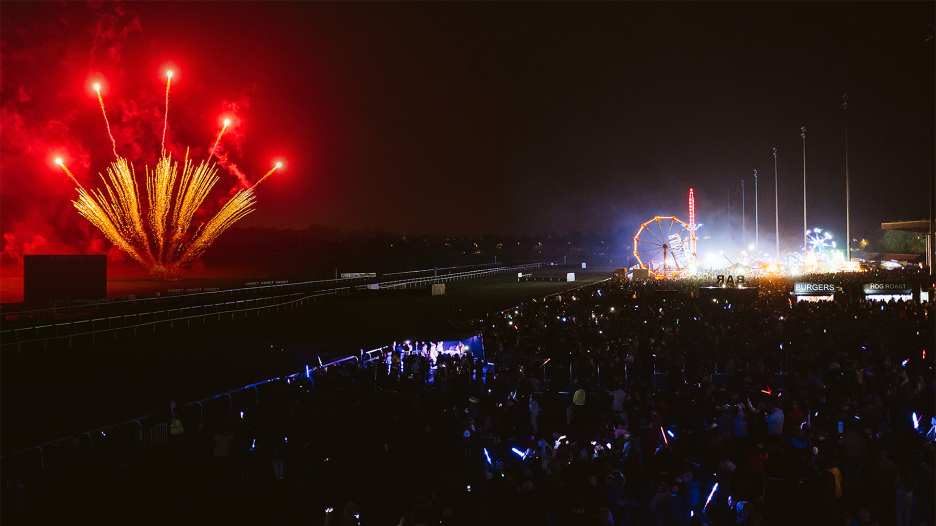 Kempton Park Racecourse Fireworks. Image courtesy of Kempton Park Racecourse. A red firework display at Kempton Park Racecourse