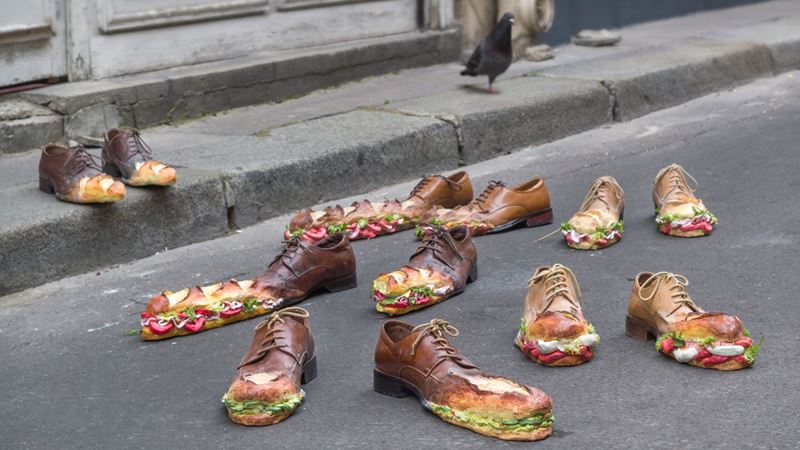 Check our eye-catching installations during Hackney Art week, such as Jeanne Gourlaouen's The Sandwich Walk © Copyright 2026 Hackney Art Week. Image courtesy of Hackney Art Week. Jeanne Gourlaouen's The Sandwich Walk art installation on a road and pavement showing realistic brogue shoes featuring toe-caps that resemble baguette sandwiches.