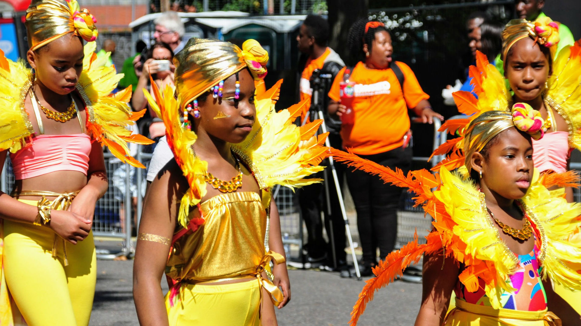 Families will love watching, or even taking part, in the exciting Children's Parade at Notting Hill Carnival. Image courtesy of Carnival Village Trust. Photo credits: Tara Hobson. A photo of children dressed in yellow costumes at the Notting Hill Carnival.