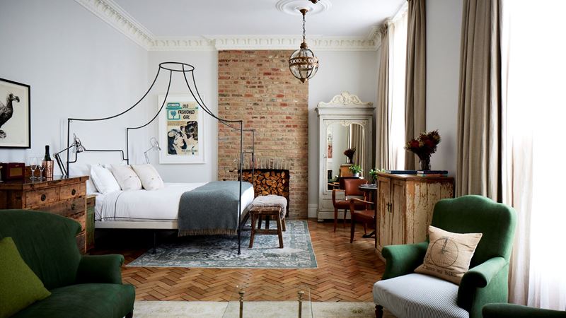Appreciate the quirky details that run throughout the Artist Residence hotel. Credit: Artist Residence London. Image courtesy of Artist Residence London. Room inside the Artist Residence with a four-poster bed, wooden parquet flooring and homely furniture